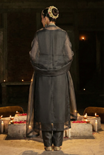 ROZAIB Anthracite Coal designer stitched suit in premium organza fabric. This luxury ready to wear stitched dress features architectural floating spine stitching and master tailoring. A minimalist 3-piece stitched suit for women, perfect for executive office wear and festive occasions, paired with raw silk trousers and a matching organza dupatta.