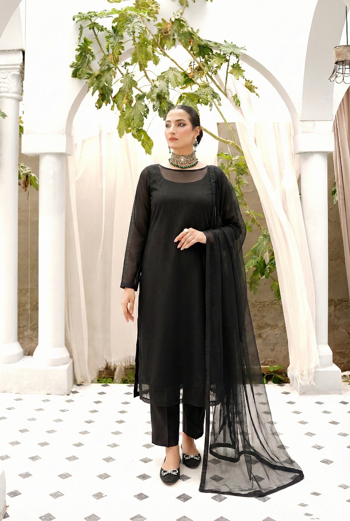 ROZAIB Coal Black luxury Bareeze net high slit stitched suit. This premium ready to wear stitched dress features a straight long kurta with 16-inch reinforced side slits, ultra-fine 0.3mm micro-mesh texture, and a clean boat neckline. A minimalist 3-piece stitched suit for women in a deep neutral coal black tone, paired with raw silk cigarette trousers and an airy Bareeze net dupatta. Designed for a sharp, sophisticated festive look with zero embroidery.