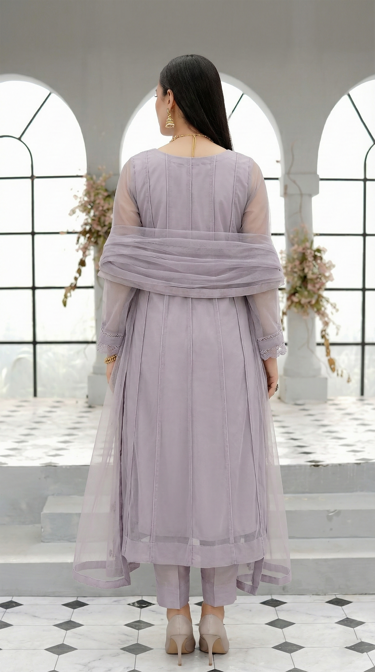 ROZAIB Lavender Grey luxury Bareeze net soft panel stitched suit. This premium ready to wear stitched dress features a 6-panel long frock silhouette with ultra-fine 0.3mm micro-mesh texture and master-tailored vertical panel lines. A minimalist 3-piece stitched suit for women in a cool muted lilac-grey tone, paired with raw silk cigarette trousers and an airy Bareeze net dupatta. Designed for a calm, sophisticated festive look with zero embroidery and precision stitching.