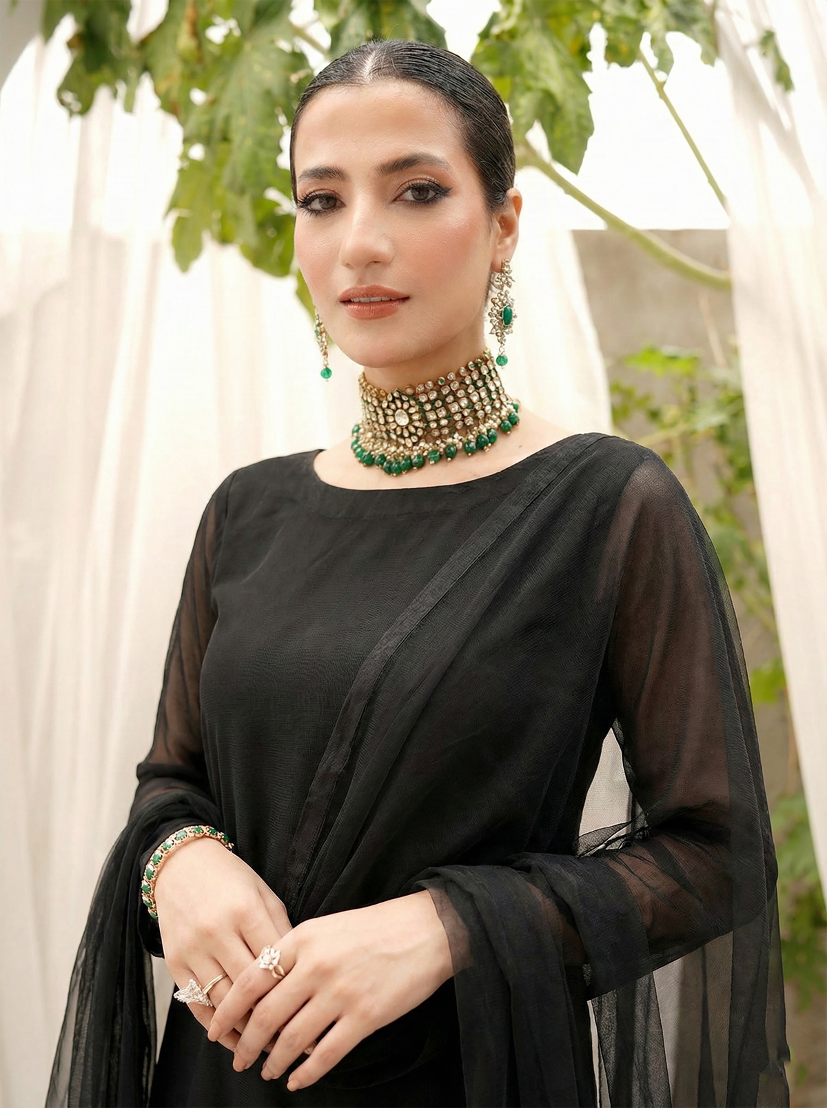 ROZAIB Coal Black luxury Bareeze net high slit stitched suit. This premium ready to wear stitched dress features a straight long kurta with 16-inch reinforced side slits, ultra-fine 0.3mm micro-mesh texture, and a clean boat neckline. A minimalist 3-piece stitched suit for women in a deep neutral coal black tone, paired with raw silk cigarette trousers and an airy Bareeze net dupatta. Designed for a sharp, sophisticated festive look with zero embroidery.