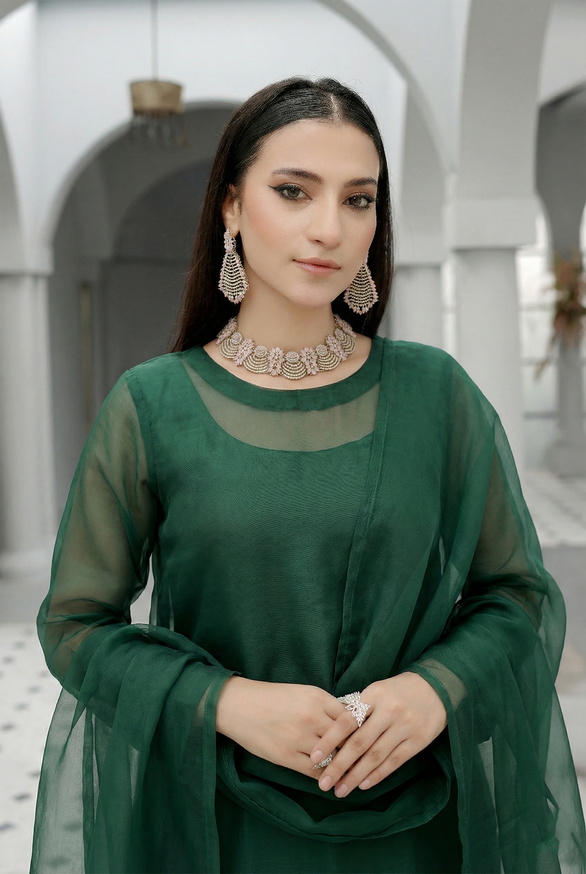 ROZAIB Forest Green luxury organza stitched suit for women. This premium ready to wear stitched dress features a unique suspended-yoke architecture with a floating vertical structure and master-tailored seamless finish. A minimalist 3-piece stitched suit in a rich forest green earthy tone, paired with raw silk relaxed trousers and a matching airy organza dupatta. Designed for a calm, authoritative executive look with zero embroidery.