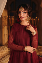 ROZAIB Deep Maroon luxury organza long frock stitched suit. This premium ready to wear stitched dress features a sophisticated light flare silhouette with 6-panel construction and sheer organza sleeves. A minimalist 3-piece stitched suit for women in a rich wine-red tone, paired with raw silk cigarette trousers and a lightweight Bareeze net dupatta. Designed for high-end festive evening wear with master-tailored pressed seams.