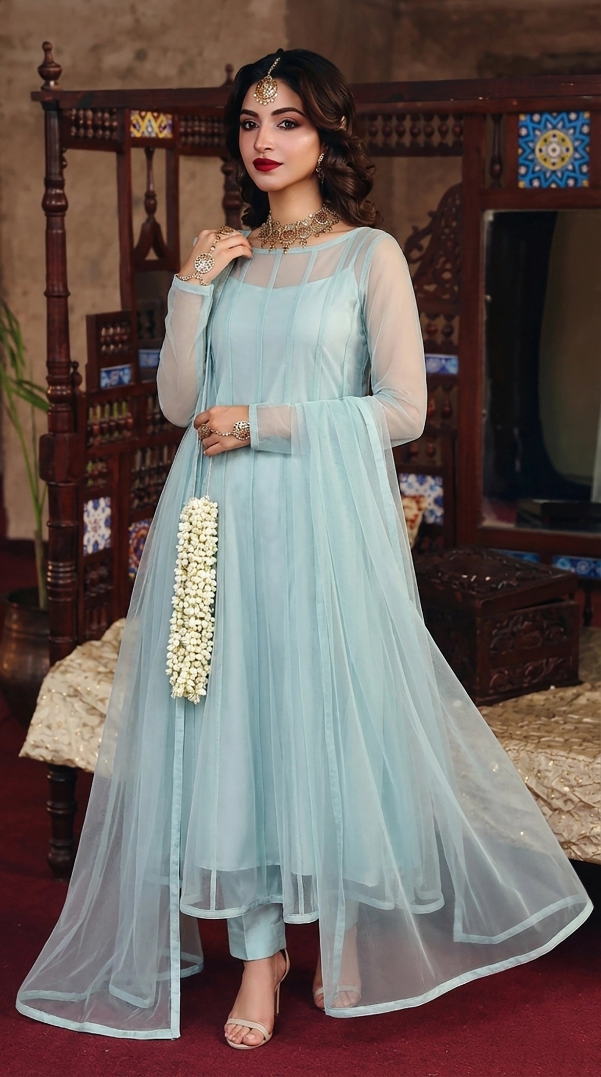 ROZAIB Aqua Mist luxury Bareeze net soft panel stitched suit. This premium ready to wear stitched dress features a sophisticated 6-panel vertical cut, ultra-fine micro-mesh texture, and master-tailored soft-release flare. A minimalist 3-piece stitched suit for women in a fresh airy pastel blue-green tone, paired with raw silk cigarette trousers and a matching Bareeze net dupatta. Designed for a calming luxury festive look with zero embroidery and precision stitching.