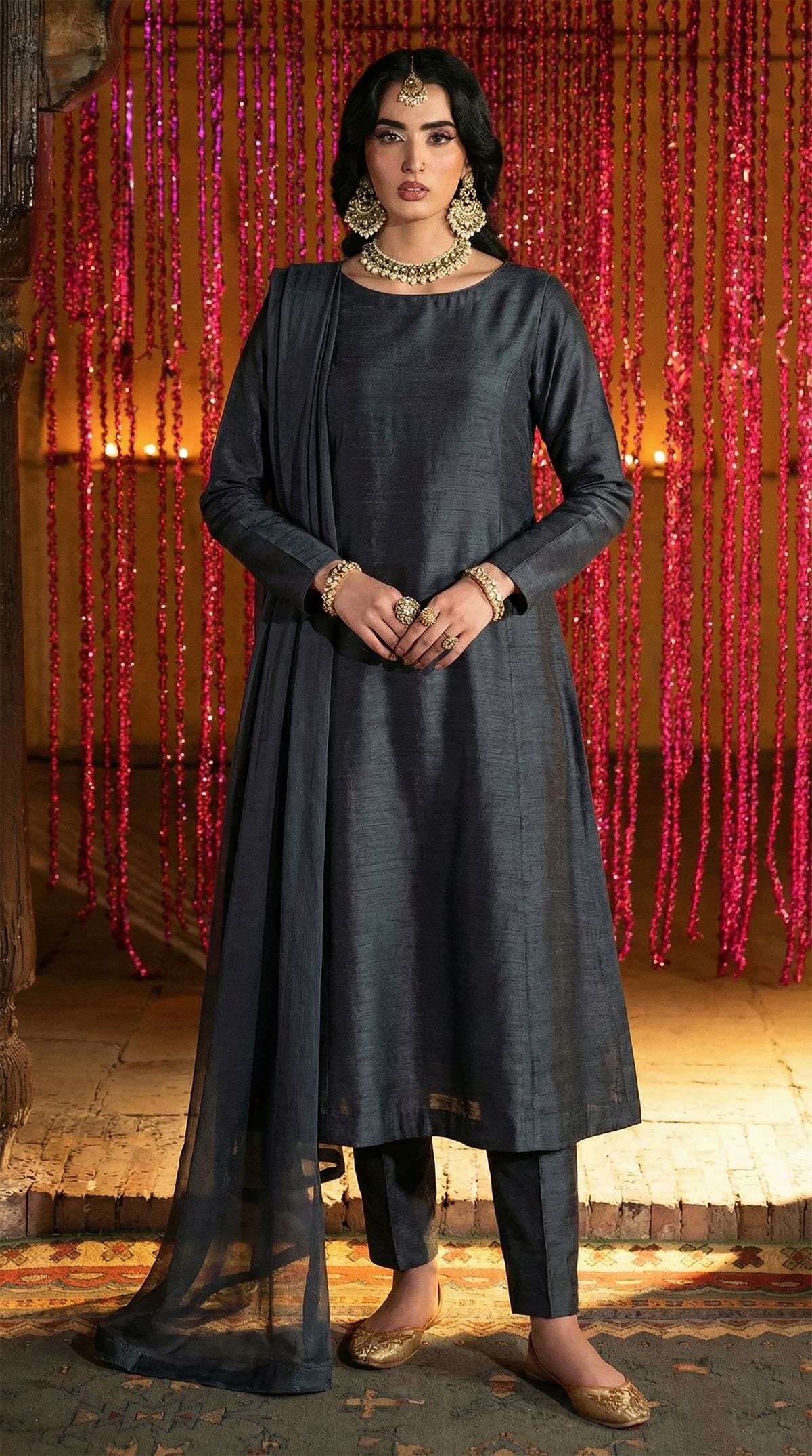 ROZAIB Deep Charcoal executive A-line stitched suit in premium raw silk fabric. This luxury ready to wear stitched dress features a sophisticated structured silhouette with authentic raw silk slub texture. A minimalist 3-piece stitched suit for women, designed for an authoritative and professional look, paired with straight cigarette pants and a matching fluid chiffon dupatta. Ideal for office wear and formal festive gatherings.