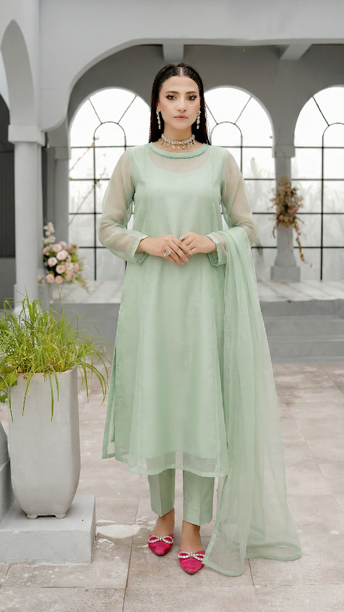 ROZAIB Pastel Green luxury A-line organza stitched suit. This premium ready to wear stitched dress features a soft structured A-line fit, ultra-fine crisp organza weave, and a master-tailored round neckline with self-fabric piping detail. A minimalist 3-piece stitched suit for women in a fresh mint-neutral tone, paired with raw silk cigarette trousers and a lightweight Bareeze net dupatta. Perfect for spring-summer festive daywear with zero embroidery.