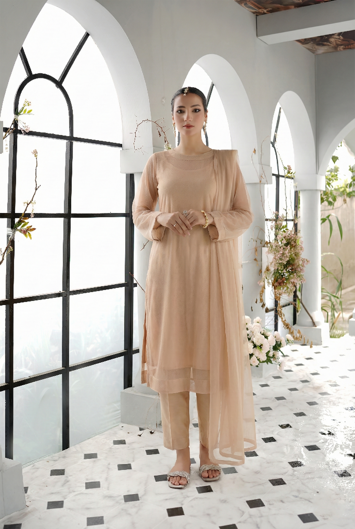 ROZAIB Biscuit Nude luxury Bareeze net long straight shirt stitched suit. This premium ready to wear stitched dress features ultra-fine 0.3mm micro-jali net texture, master-tailored straight seams, and a clean round neckline. A minimalist 3-piece stitched suit for women in a warm neutral beige tone, paired with raw silk cigarette trousers and an airy Bareeze net dupatta. Designed for a clean, sophisticated festive look with zero embroidery and precision stitching.