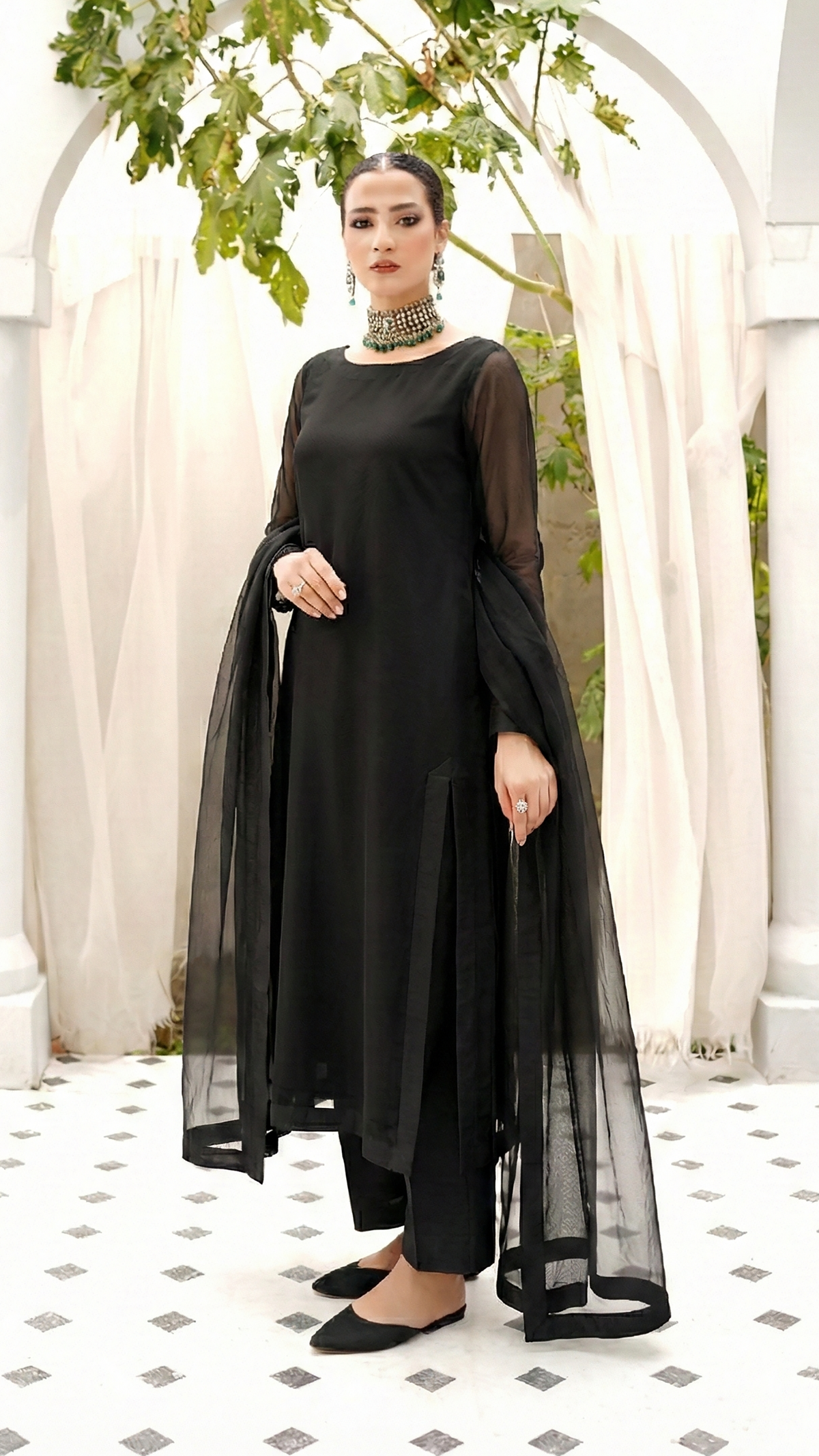 ROZAIB Coal Black luxury Bareeze net high slit stitched suit. This premium ready to wear stitched dress features a straight long kurta with 16-inch reinforced side slits, ultra-fine 0.3mm micro-mesh texture, and a clean boat neckline. A minimalist 3-piece stitched suit for women in a deep neutral coal black tone, paired with raw silk cigarette trousers and an airy Bareeze net dupatta. Designed for a sharp, sophisticated festive look with zero embroidery.
