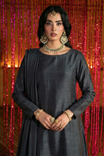 ROZAIB Deep Charcoal executive A-line stitched suit in premium raw silk fabric. This luxury ready to wear stitched dress features a sophisticated structured silhouette with authentic raw silk slub texture. A minimalist 3-piece stitched suit for women, designed for an authoritative and professional look, paired with straight cigarette pants and a matching fluid chiffon dupatta. Ideal for office wear and formal festive gatherings.
