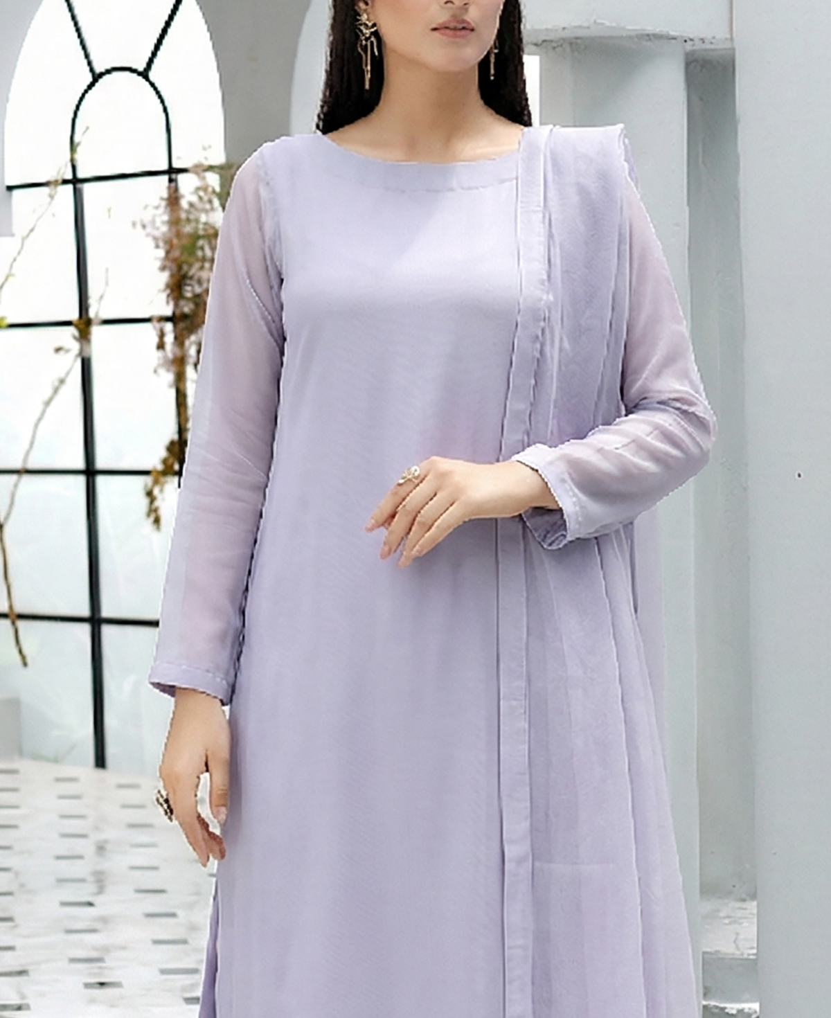 ROZAIB Ice Lilac luxury Bareeze net A-line stitched suit. This premium ready to wear stitched dress features a relaxed A-line fit, ultra-fine 0.3mm micro-mesh texture, and a clean boat neckline. A minimalist 3-piece stitched suit for women in a fresh icy lavender tone, paired with raw silk cigarette trousers and an airy Bareeze net dupatta. Designed for a calm, sophisticated festive look with zero embroidery and high-definition tailoring.