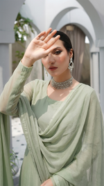 ROZAIB Sage Pista luxury Bareeze net long straight kurta stitched suit. This premium ready to wear stitched dress features a clean plain construction, ultra-fine 0.3mm micro-mesh net texture, and master-tailored vertical fall. A minimalist 3-piece stitched suit for women in a soft muted pistachio green tone, paired with raw silk cigarette trousers and an airy Bareeze net dupatta. Designed for a fresh, sophisticated festive look with zero embroidery and precision stitching.