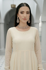 ROZAIB Ivory Cream luxury chiffon soft kalidaar stitched suit. This premium ready to wear stitched dress features a 12-panel radial construction, ultra-fine dry matte chiffon texture, and a graceful soft circular flare. A minimalist 3-piece stitched suit for women in a luminous warm ivory tone, designed for effortless festive elegance with zero embroidery and master-tailored invisible stitching.