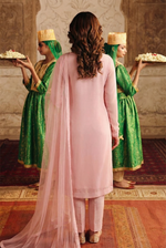 ROZAIB Pastel Pink minimal festive stitched suit in premium flowy chiffon fabric. This luxury ready to wear stitched dress features a straight relaxed flow fit with ultra-fine chiffon weave and a soft blush undertone. A minimalist 3-piece stitched suit for women designed for a fresh feminine look, paired with raw silk cigarette trousers and an airy Bareeze net dupatta. Perfect for spring-summer evening wear and formal events
