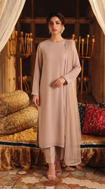 ROZAIB Nude Sand minimal festive stitched suit in premium flowy chiffon fabric. This luxury ready to wear stitched dress features a straight relaxed flow fit with ultra-fine micro chiffon grain and master-tailored vertical lines. A 3-piece stitched suit for women designed for effortless elegance, paired with raw silk cigarette trousers and a lightweight Bareeze net dupatta. Perfect for a sophisticated minimalist look in any season.