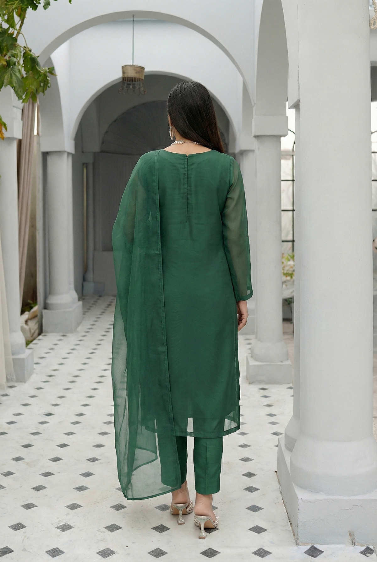ROZAIB Forest Green luxury organza stitched suit for women. This premium ready to wear stitched dress features a unique suspended-yoke architecture with a floating vertical structure and master-tailored seamless finish. A minimalist 3-piece stitched suit in a rich forest green earthy tone, paired with raw silk relaxed trousers and a matching airy organza dupatta. Designed for a calm, authoritative executive look with zero embroidery.