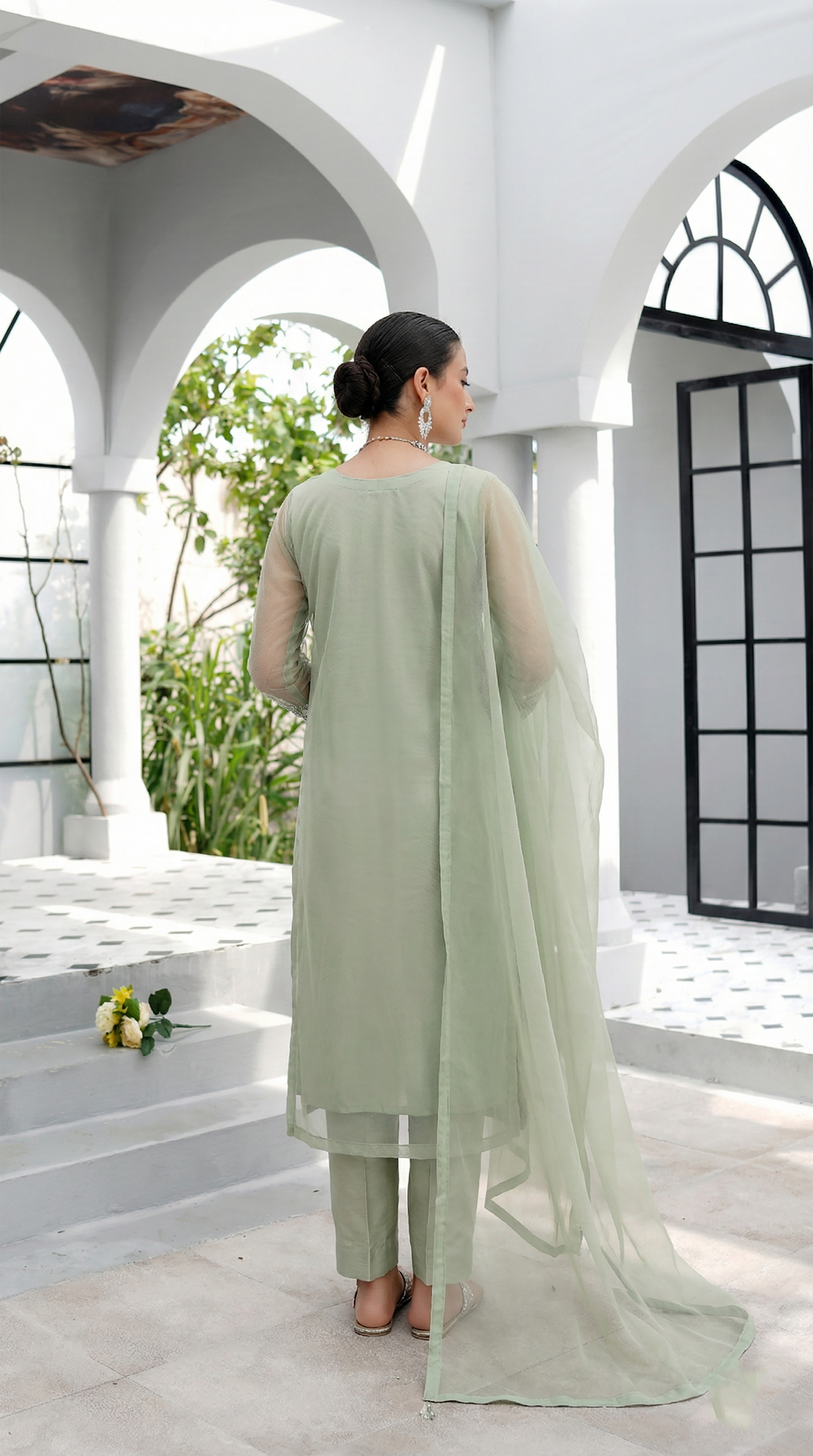 ROZAIB Sage Pista luxury Bareeze net long straight kurta stitched suit. This premium ready to wear stitched dress features a clean plain construction, ultra-fine 0.3mm micro-mesh net texture, and master-tailored vertical fall. A minimalist 3-piece stitched suit for women in a soft muted pistachio green tone, paired with raw silk cigarette trousers and an airy Bareeze net dupatta. Designed for a fresh, sophisticated festive look with zero embroidery and precision stitching.