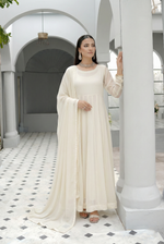 ROZAIB Ivory Cream luxury chiffon soft kalidaar stitched suit. This premium ready to wear stitched dress features a 12-panel radial construction, ultra-fine dry matte chiffon texture, and a graceful soft circular flare. A minimalist 3-piece stitched suit for women in a luminous warm ivory tone, designed for effortless festive elegance with zero embroidery and master-tailored invisible stitching.