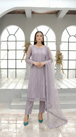 ROZAIB Lavender Grey luxury Bareeze net soft panel stitched suit. This premium ready to wear stitched dress features a 6-panel long frock silhouette with ultra-fine 0.3mm micro-mesh texture and master-tailored vertical panel lines. A minimalist 3-piece stitched suit for women in a cool muted lilac-grey tone, paired with raw silk cigarette trousers and an airy Bareeze net dupatta. Designed for a calm, sophisticated festive look with zero embroidery and precision stitching.