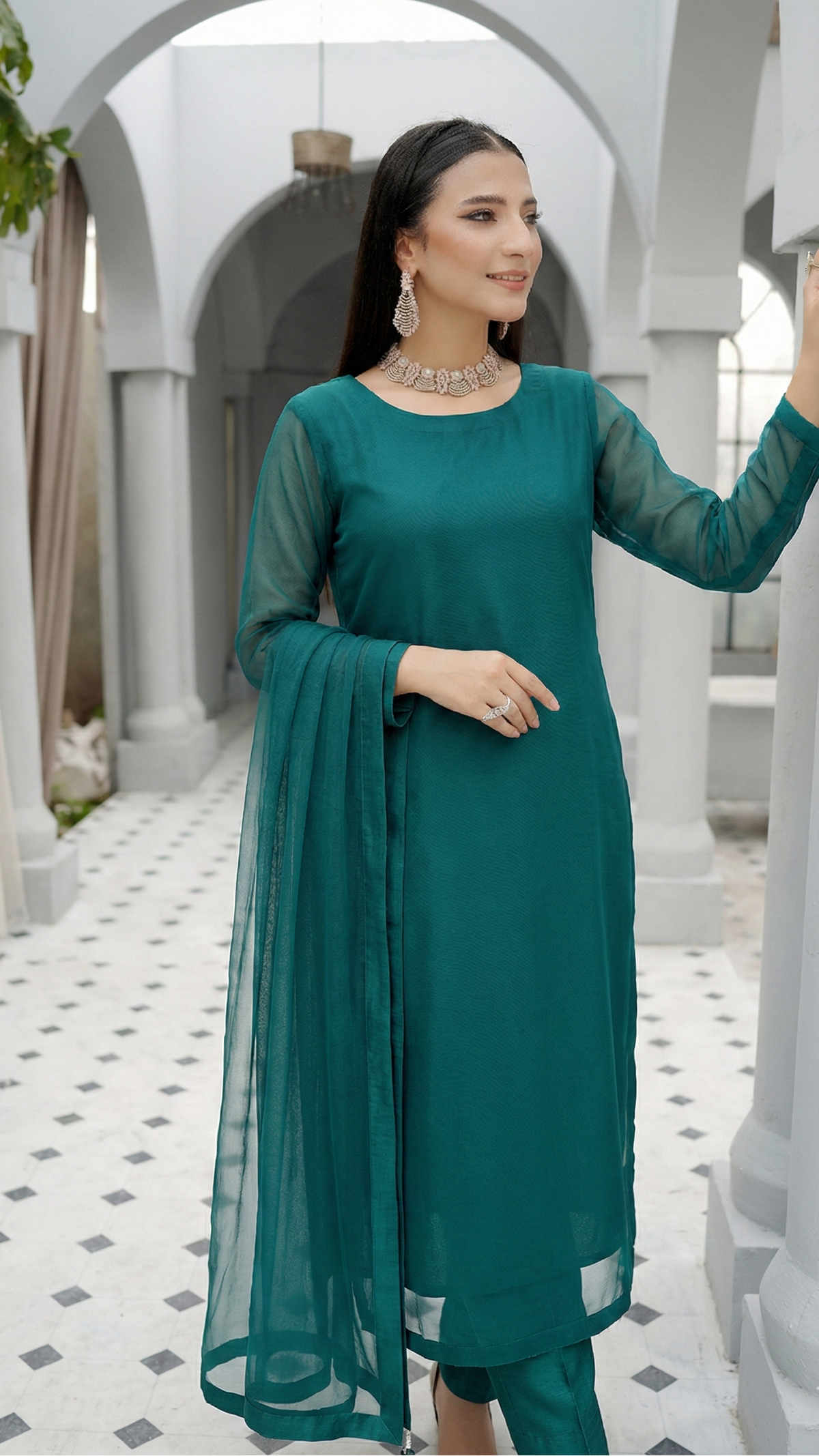 ROZAIB Peacock Green luxury Bareeze net stitched suit. This premium ready to wear stitched dress features Optical Spine Architecture for a perfect vertical fall, 0.3mm micro-jali net texture, and master-tailored straight silhouette. A minimalist 3-piece stitched suit for women in a rich jewel tone, paired with raw silk loose shalwar and a matching Bareeze net dupatta. Designed for a high-end festive-formal look with zero embro
