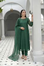 ROZAIB Forest Green luxury organza stitched suit for women. This premium ready to wear stitched dress features a unique suspended-yoke architecture with a floating vertical structure and master-tailored seamless finish. A minimalist 3-piece stitched suit in a rich forest green earthy tone, paired with raw silk relaxed trousers and a matching airy organza dupatta. Designed for a calm, authoritative executive look with zero embroidery.