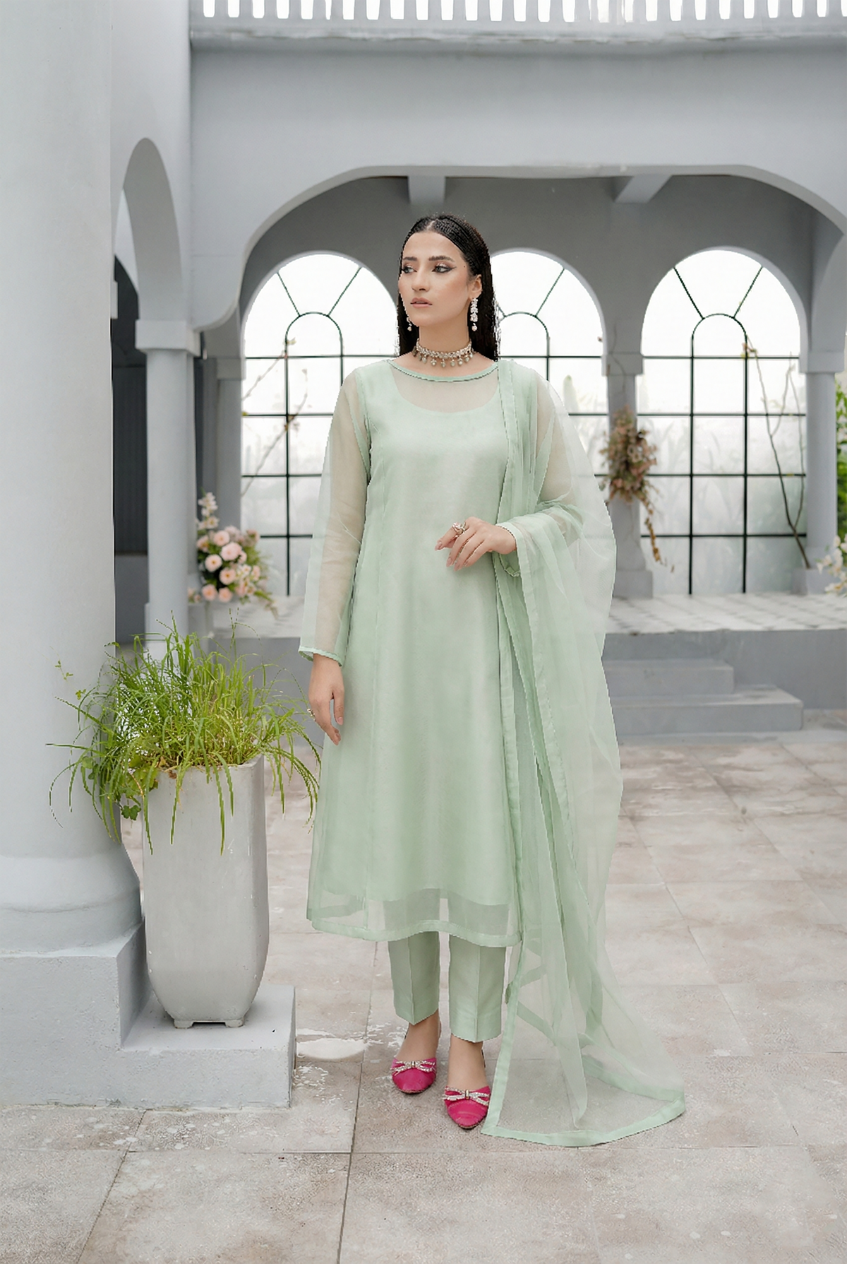 ROZAIB Pastel Green luxury A-line organza stitched suit. This premium ready to wear stitched dress features a soft structured A-line fit, ultra-fine crisp organza weave, and a master-tailored round neckline with self-fabric piping detail. A minimalist 3-piece stitched suit for women in a fresh mint-neutral tone, paired with raw silk cigarette trousers and a lightweight Bareeze net dupatta. Perfect for spring-summer festive daywear with zero embroidery.
